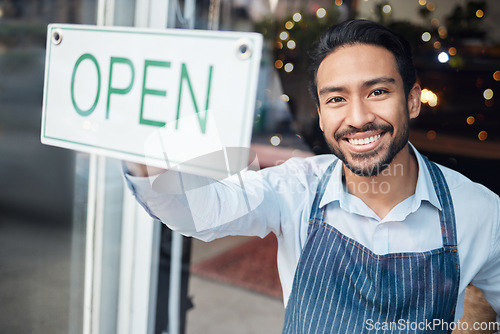 Image of Happy Asian man, small business and smile with open sign on window for service in coffee shop or restaurant. Portrait of male entrepreneur holding billboard or poster for opening retail store or cafe