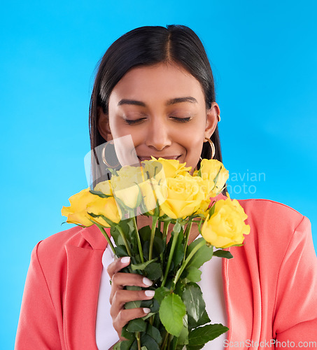 Image of Scent, flowers and roses with woman in studio for gift, satisfaction and spring. Relax, happy and floral present with female and bouquet isolated on blue background for aroma, natural and products