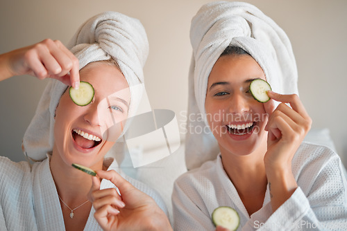 Image of Friends, cucumber and teenager, girl and facial, happy with pampering and beauty in portrait with skincare treatment. Happiness, people have fun together and female friendship, cosmetics and laughter