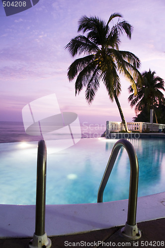 Image of luxury infinity swimming pool caribbean sunset