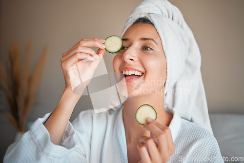 Image of Happy woman, cucumber and natural skincare for beauty, cosmetics or facial treatment at spa. Female smiling and applying vegetable to eyes for organic healthcare, hydration or dermatology at salon