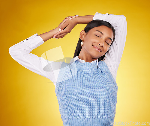 Image of Relax, stretching and a woman on a yellow background in studio for peace, quiet or free time. Freedom, sleepy or lifestyle and an attractive young female posing with her eyes closed for a stretch