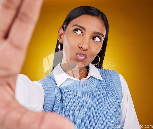 Image of Selfie, happy woman and kiss in studio isolated on a brown background or backdrop. Thinking, idea and Indian person taking photo for memory, social media or profile picture for photography pout.