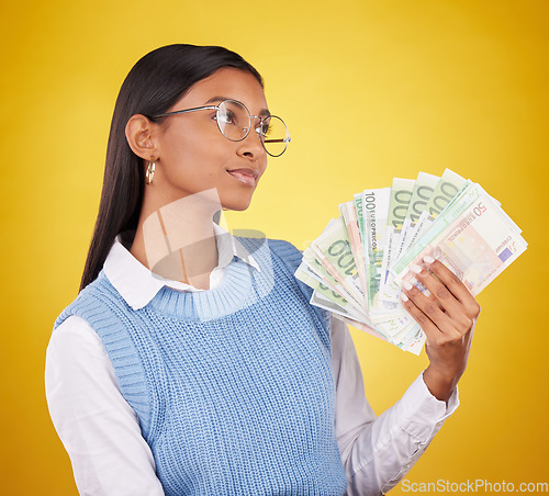 Image of Young woman and money fan isolated on studio background of wealth, cash winning or financial freedom ideas. Rich and confident indian person or winner thinking of investing bonus, cashback or lottery