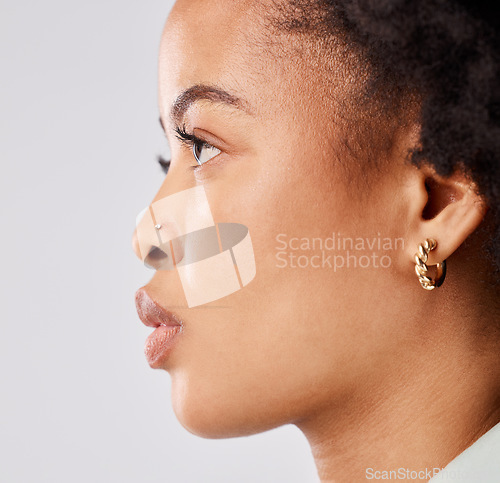 Image of Serious, side profile and face of a black woman isolated on a white background in a studio. Focus, thinking and an African girl looking thoughtful, contemplating and taking a headshot on a backdrop