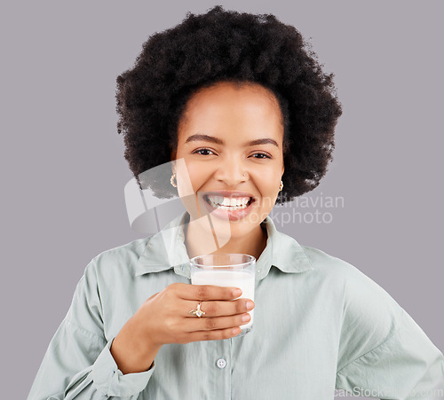 Image of Portrait, woman and smile with milk in studio, white background and backdrop for healthy diet. Female model, glass and calcium of smoothie, vanilla milkshake and nutrition of detox weight loss drink