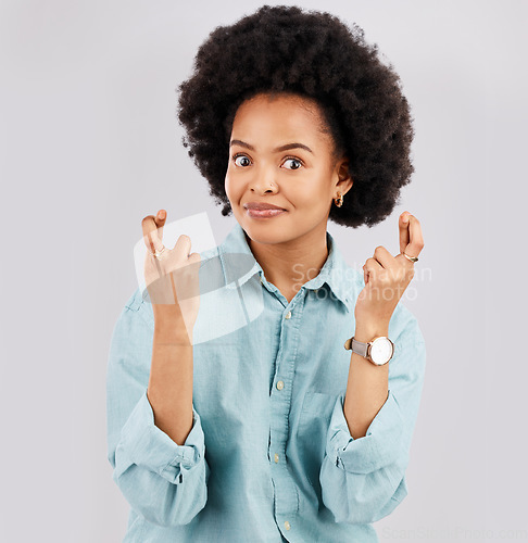 Image of Luck, woman portrait and hands and fingers crossed with hope and in a studio. Isolated, gray background and young female model with surprise face and emoji hand sign hopeful and waiting for win