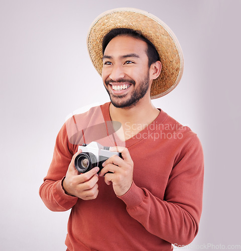 Image of Travel, camera and happy asian man on holiday, adventure and photography on white background. Smile on face, tourism and Indian photographer or journalist on vacation, happiness on journey in studio.