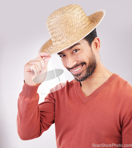 Image of Happy, handsome and portrait of an Asian man with a hat isolated on a white background in studio. Smile, trendy and a guy wearing headwear made of straw with confidence and happiness on backdrop