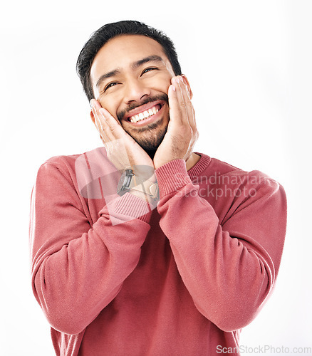 Image of Face, shy and in love with a man in studio isolated on a white background while touching his cheeks. Thinking, coy and cute with a handsome young indian male feeling special on valentines day