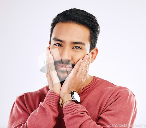 Image of Portrait, shy and in love with a man in studio isolated on a white background while touching his cheeks. Face, coy and cute with a handsome young indian male feeling special on valentines day