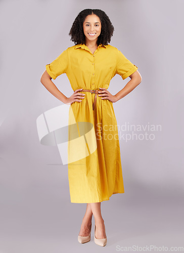 Image of Smile, woman and portrait in studio, fashion and background with style, confidence or happiness. Happy female model posing in yellow dress, positive attitude and empowerment of pride, joy and trendy