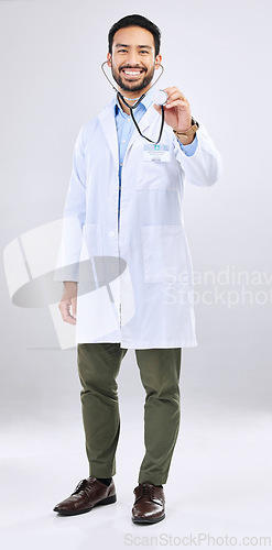 Image of Doctor, man and listen with stethoscope, smile in portrait and cardiovascular health isolated on studio background. Medical professional, happy male physician with healthcare, cardiology and surgeon