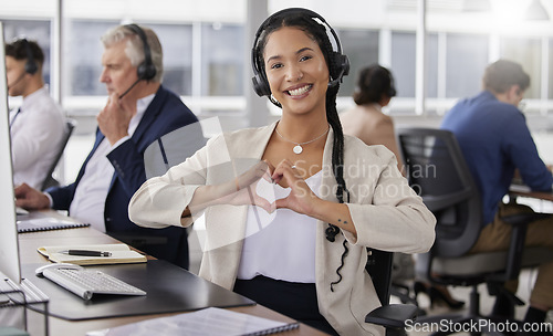 Image of Hands, heart and portrait of happy woman in call center for customer care, excellence and sales support in office. Female consultant, gesture and love sign for telemarketing services, emoji and smile