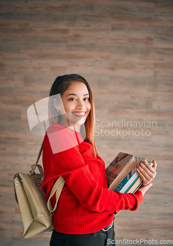 Image of Portrait, books and education with a student woman on a wooden background for learning at college or university. School, study and scholarship with an attractive young female pupil wearing a backpack