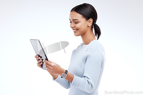 Image of Woman, tablet and reading in studio by white background for planning, schedule and smile for website. Girl, student and excited on mobile touchscreen app for research, calendar or social network chat