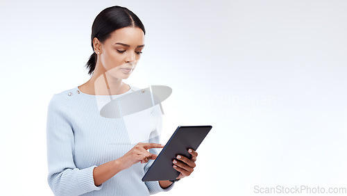 Image of Woman, tablet and reading in studio by white background for planning, schedule and search on web app. Girl, student and typing on mobile touchscreen for research, calendar or studying by mockup space