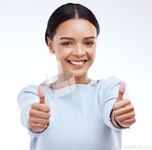 Image of Woman, thumbs up and happy in studio portrait with happiness, confidence or success by white background. Girl, model and student with smile, hand gesture or agreement for winning, goal or achievement