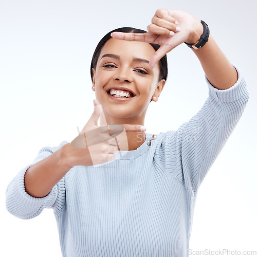 Image of Frame, hands and portrait of woman on a white background for beauty, cosmetics and natural makeup. Fashion, focus mockup and face of girl isolated with happiness, smile or photography emoji in studio