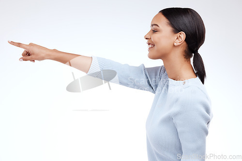 Image of Studio, profile and happy model pointing at sales promotion, advertising copy space and discount deal mockup. Brand commercial, marketing and product placement gesture for woman on white background