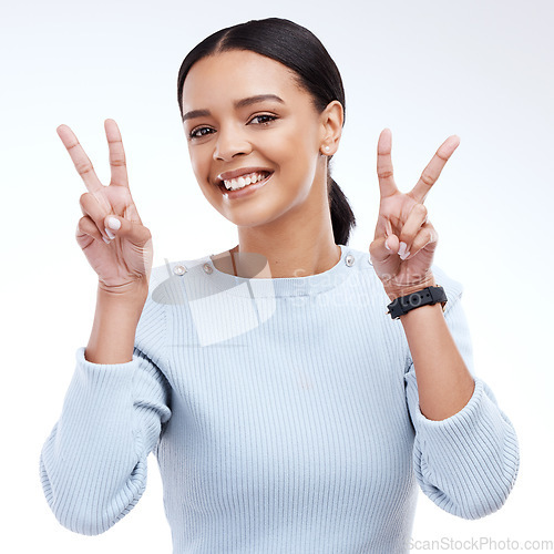 Image of Peace sign, woman and portrait emoji gesture in a studio with happiness, cool and excited facial expression. Female, isolated and white background of gen z model with a happy smile and v hands