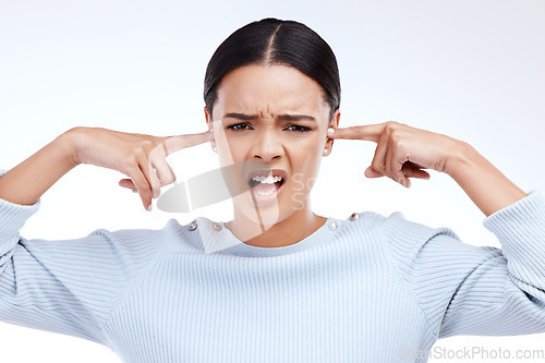 Image of Portrait, woman and finger in ears for noise, silence and denial gesture on studio white background. Omg, face and angry girl with complaint, ignoring and deaf, wtf and emoji, frustrated and annoyed