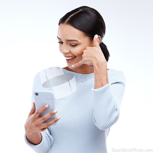 Image of Phone call, sign and woman isolated on a white background for networking, contact and communication on mobile app. Happy young person talking, hello or conversation on cellphone service in studio