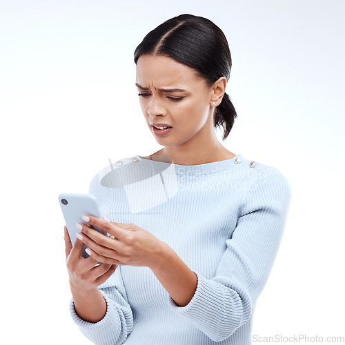 Image of Confused, woman and phone in a studio reading a phishing, scam and fake news text. Isolated, white background and mobile texting of a young and gen z female with online and spam email with wtf