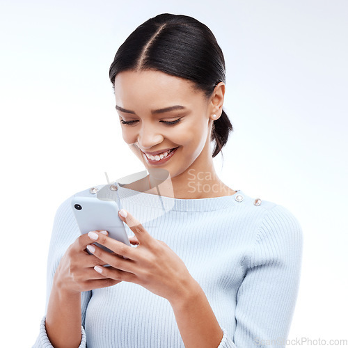 Image of Phone, typing and happy woman isolated on a white background for social media, funny meme or internet chat. Young person networking, communication or reading news or post on mobile app in studio