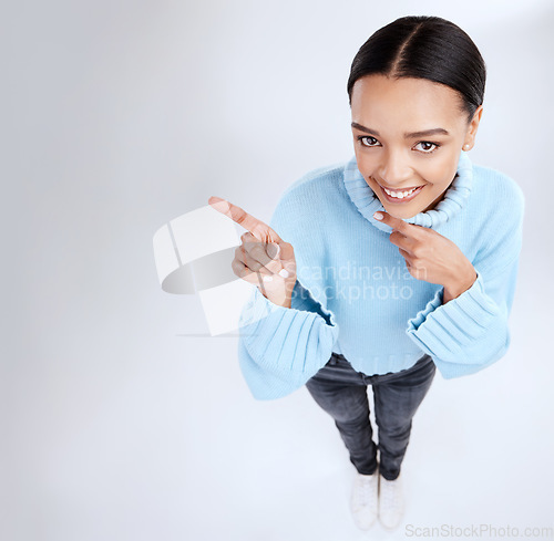 Image of Happy mockup portrait, woman face and pointing at sales promotion, advertising copy space or discount deal mock up. Brand commercial, studio top view or product placement female on white background