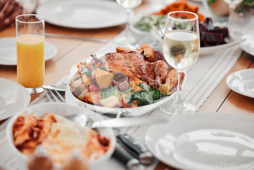 Image of Food, dinner and party with drinks and table setting, celebration and holiday with Christmas or thanksgiving. Social event, gathering and wine, chicken and juice with gourmet meal, festive and feast