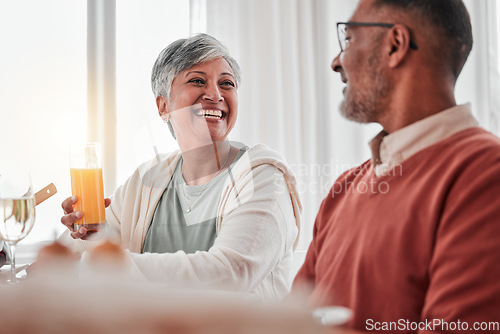 Image of Happy, elderly and a couple talking at breakfast, laughing at a joke and enjoying juice together. Smile, morning and a senior man and woman enjoying a lunch while speaking and bonding at home