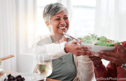 Image of Family dinner, senior woman and salad of a happy female with heathy food in a home. Celebration, together and people with unity from eating at table with happiness and a smile in a house giving meal