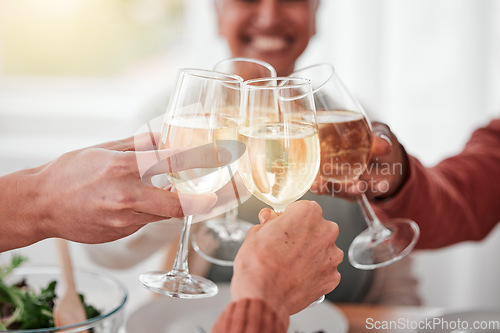 Image of People, hands and cheers for happy dinner, fine dining or celebration for meal or friendship together. Hand of family or friends toasting by table for food, drink or bonding in celebration at home