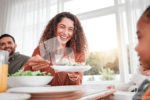 Image of Family dinner, happy woman and salad with children at home for nutrition. Celebration, together and people with kids eating at table with happiness and a smile in a house giving lunch on plate