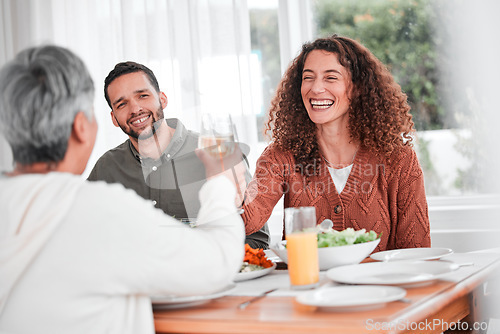 Image of Family dinner, couple and cheers of a happy woman with healthy food in a home. Celebration, together and people with unity from eating at table with happiness and a smile in a house with toast