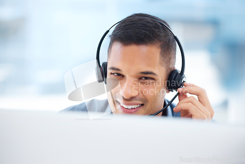Image of Call center, headset or friendly man in communication at telecom customer services on microphone. Smile, crm office or happy sales agent consulting, speaking or talking in technical support help desk