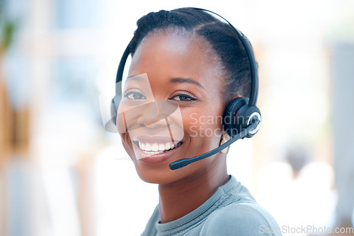 Image of Happy, portrait and a black woman in call center with a smile for consulting and telemarketing. Contact us, happiness and the face of an African customer service agent working in online support