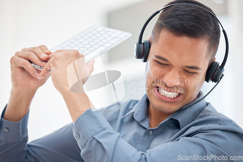 Image of Stress, frustrated or angry man in call center breaking computer keyboard in crm consulting fail or 404 glitch. Anger problem, crazy screaming or mad customer services agent in technology smash