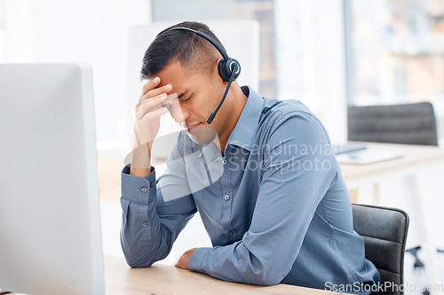 Image of Headache, migraine pain or man in call center with burnout feeling overworked in crm communication. Stressed, office or tired telemarketing sales agent with anxiety, fatigue or mental health problems