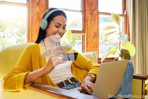 Image of Woman, laptop and credit card with ecommerce and headphones to listen to music while online shopping. Happy female relax at home, podcast or radio streaming with fintech, internet banking and payment