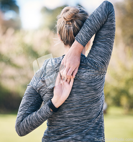 Image of Back of woman, fitness and stretching arms for exercise, training and sports in park. Female athlete warm up for workout, performance and energy outdoors in nature, wellness and runner commitment