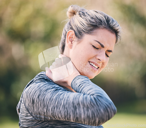 Image of Fitness, injury and woman with neck pain in a park during running routine on blurred background. Spine, problem and girl suffering from injured muscle, arthritis or shoulder strain after workout run