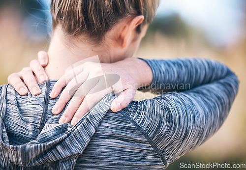 Image of Fitness, injury and back pain by woman in a park during running routine on blurred background. Neck, problem and girl suffering from injured muscle, arthritis or shoulder strain after workout run