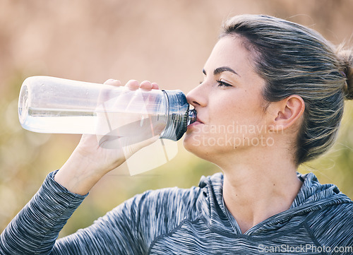 Image of Woman drinking water at park for health, break and energy for workout, training and diet. Thirsty female, bottle and fitness nutrition for hydration, sports wellness and muscle recovery from exercise