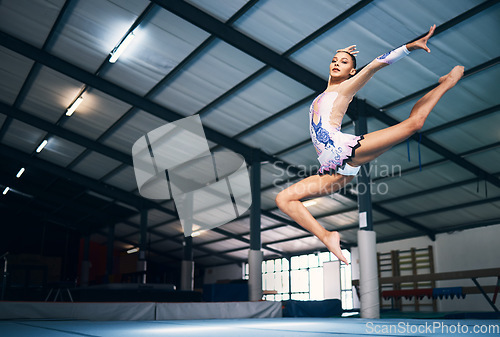 Image of Dance, jump and a woman in gymnastics practice, artistic hobby and competition for sport. Fitness, creative and a female gymnast practicing a routine, jumping and dancing for a sports performance