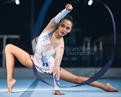 Image of Ribbon, gymnastics and portrait of woman in performance, dance training and sports competition. Female, rhythmic movement and flexible dancing athlete, gymnast and talent for concert event in arena