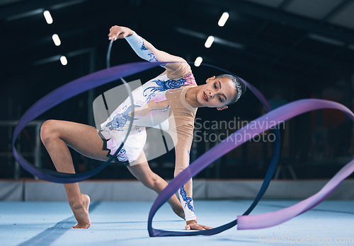Image of Ribbon, gymnastics and woman dancer in performance, action and sports competition. Female, rhythmic movement and flexible dancing athlete, creative skill and talent of concert event in practice arena