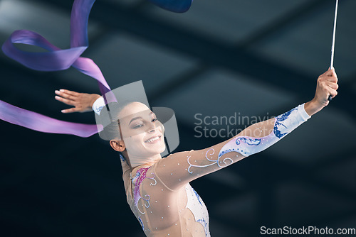 Image of Ribbon gymnastics, happy woman and dancing in performance, training show and sports competition. Female, rhythmic movement and dancer smile for action, creative talent and energy for concert in arena