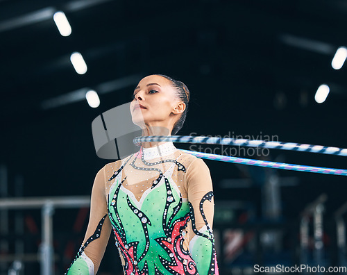 Image of Woman, gymnastics and spinning hoop on neck for competition, sports training and action in arena. Female dancer, rhythmic movement and athlete with loop for dynamic solo concert, event or performance